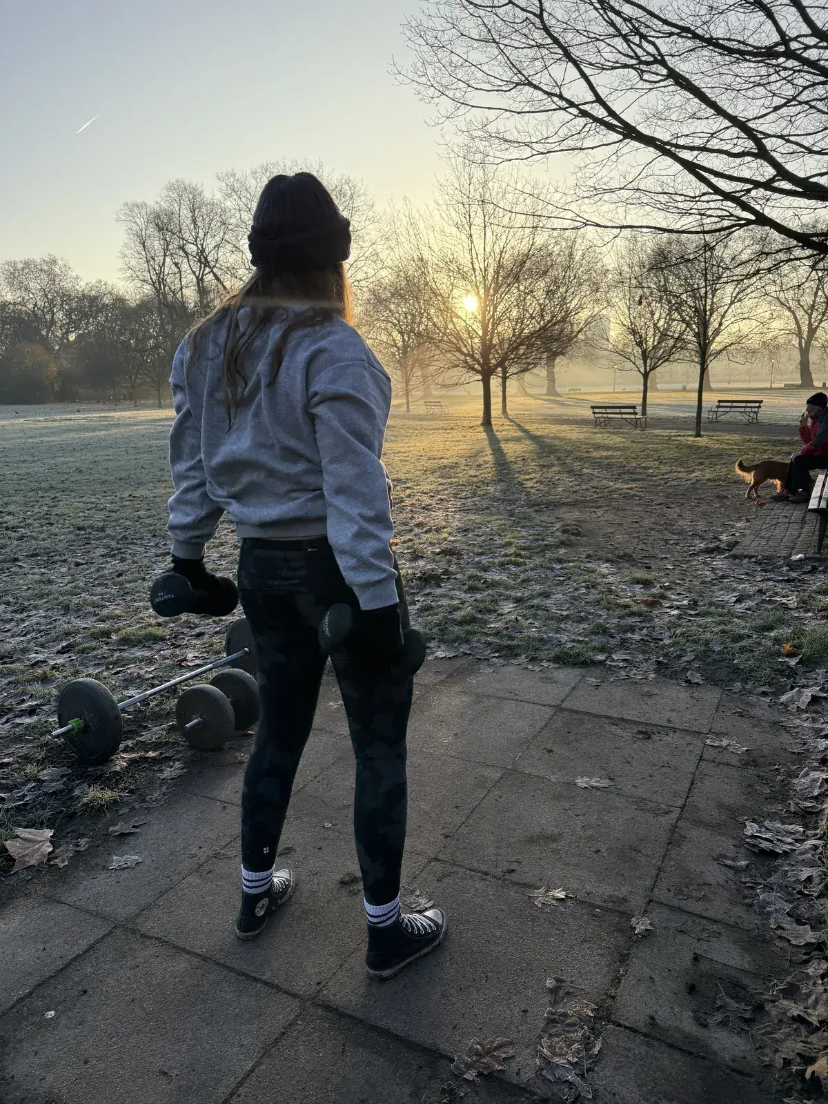 Client training with dumbbells in Battersea Park at sunrise